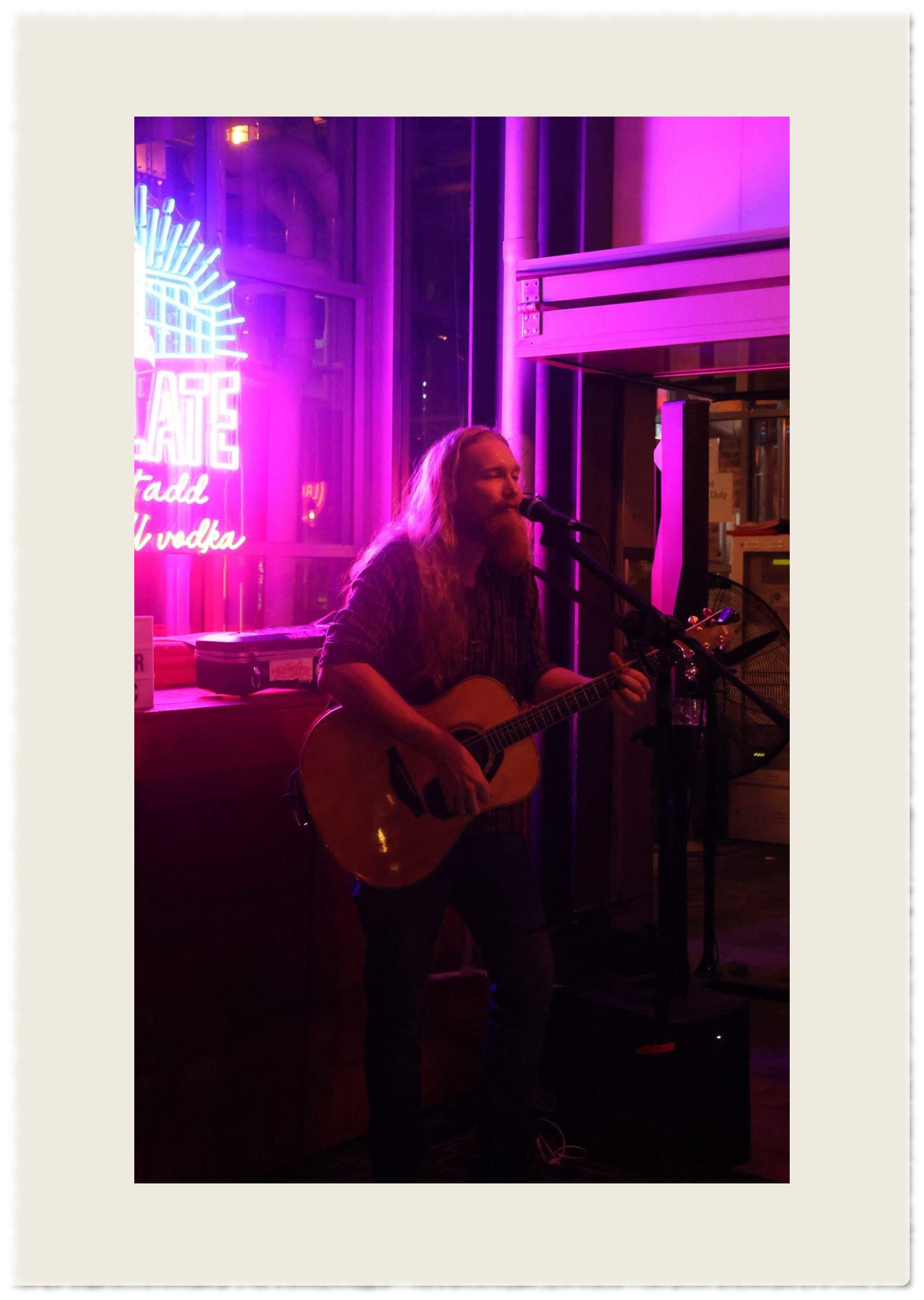 Local musician playing the guitar and singing covers
